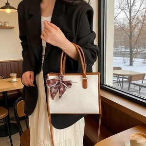 Chic snake-patterned white tote bag with brown leather handles and heart print silk scarf
