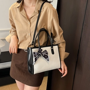 Chic beige snake pattern tote bag with black strap and decorative heart print scarf