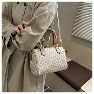 Detail of Boston bag showing the geometric pattern and contrast red edge stitching
