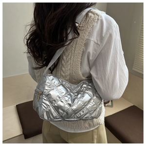 Macro detail of silver quilted pattern and metallic texture on large hobo shoulder bag