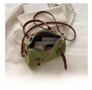 Interior view of green barrel bag showing capacity for phone, wallet and cosmetics