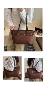 Detail of a large brown suede tote bag with golden twist lock and vintage strap