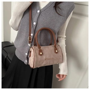 Detail shot of the mini Boston bag featuring frosted texture and adjustable strap
