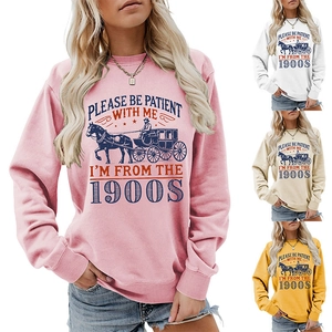 Close-up of retro crewneck sweatshirts in pink, white, beige, and yellow with carriage print