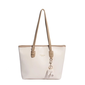 Minimalist beige tote bag with khaki trim and cute elephant charm on white background
