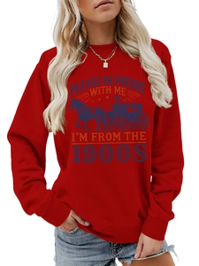 Detail of red crewneck sweatshirt featuring retro horse carriage print and graphic text