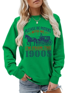 Detail of bright green sweatshirt with Please Be Patient 1900s print and horse carriage