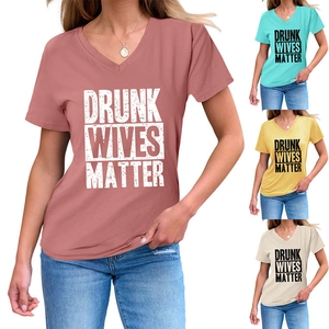 Detail view of V-neck short sleeve T-shirts in dusty rose, mint, yellow and cream colors