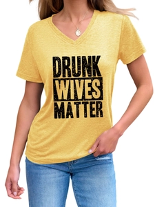 Detail of V-neck mustard t-shirt featuring Drunk Wives Matter graphic print with denim