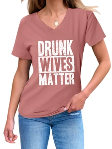Detail of V-neck dusty pink t-shirt with Drunk Wives Matter vintage print and gold necklace