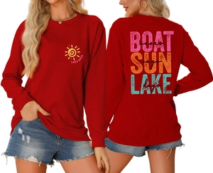 Detail of red crewneck sweatshirt featuring Lake Days sun print and wave back graphic