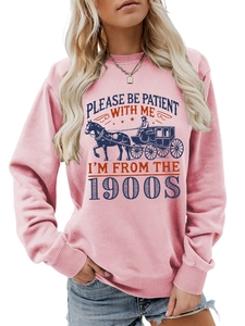 Close-up of retro pink sweatshirt with Please Be Patient With Me 1900s print detail