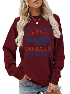 Close-up of retro graphic and vintage lettering on burgundy crewneck sweatshirt