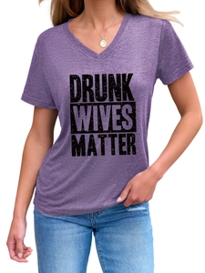 Close-up of Drunk Wives Matter lettering on a heather purple V-neck short sleeve T-shirt