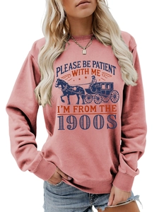 Detail of pink sweatshirt featuring retro carriage graphic and 1900s slogan print