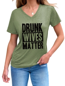 Detail of Drunk Wives Matter slogan on green V-neck T-shirt with fabric texture