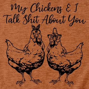 Detail of burnt orange cotton T-shirt featuring funny cartoon chickens and humorous text