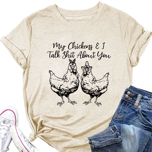 Flat lay of women's apricot cotton t-shirt with funny chicken graphic and blue jeans