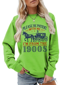 Detailed view of neon green sweatshirt with 1900s slogan and vintage carriage graphic