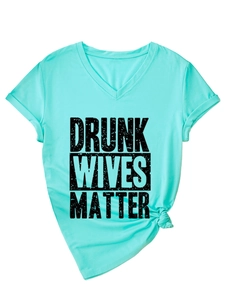 Close-up of mint green V-neck T-shirt with Drunk Wives Matter print and knotted hem