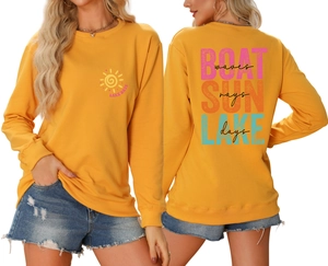 Close-up of yellow sweatshirt featuring Lake Days and Boat Waves artistic prints