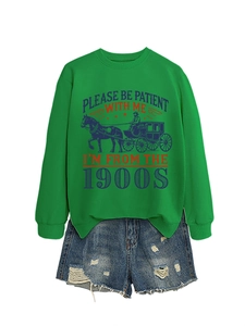 Detail of green crewneck sweatshirt with retro slogan and distressed denim shorts set