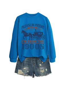 Close-up of retro blue sweatshirt with 1900s slogan and ripped denim shorts set
