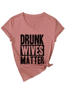 Detail of V-neck dusty rose t-shirt with Drunk Wives Matter graphic and knotted hem