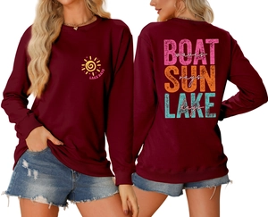 Front and back detail of burgundy sweatshirt featuring Boat Sun Lake Waves art design