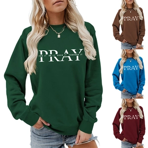 Close-up of PRAY slogan print on colorful crewneck sweatshirts in various trendy shades