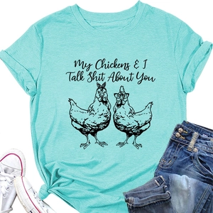 Close-up of turquoise crew neck T-shirt with funny chicken graphic and humorous text