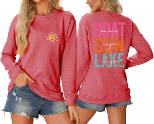 Detail view of coral pink Lake Days sweatshirt with colorful graphic sun and wave prints