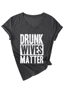 Detail of dark grey V-neck t-shirt with knotted hem and Drunk Wives Matter print