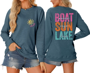 Close-up of boat waves and sun rays graphic print on casual blue sweatshirt back