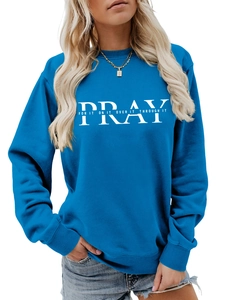Detail of the white PRAY letter print on a royal blue crewneck sweatshirt for women