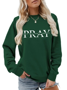 Detail of Pray For It crewneck sweatshirt showing white typography on dark green fabric