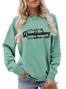 Detail of mint green sweatshirt featuring bold black slogan print on soft cotton fabric