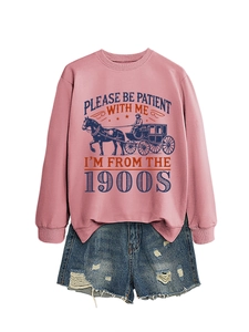 Detail of pink sweatshirt with vintage carriage print and frayed denim shorts