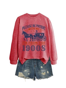 Detail of red sweatshirt with 1900s print paired with distressed denim shorts