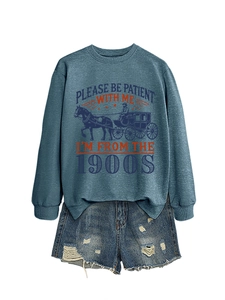 Flat lay of gray long-sleeve sweatshirt with vintage print and distressed denim shorts