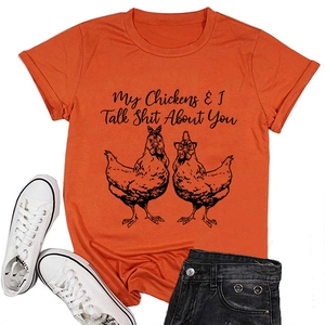 Close-up of orange t-shirt with funny chicken graphic and humorous quote text