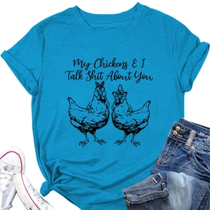 Flat lay of bright blue cotton t-shirt featuring funny chicken graphic and quote