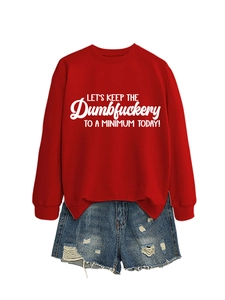 Detail of red crewneck sweatshirt with white text and distressed denim shorts set