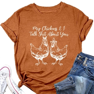 Detail of burnt orange t-shirt with My Chickens talk graphic and knotted hem design