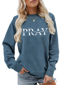 Detail of navy blue sweatshirt showing white Pray For It On It typography and fabric texture