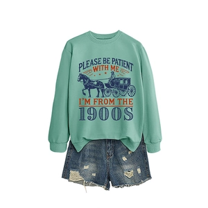 Mint green '1900s' graphic sweatshirt paired with distressed blue denim shorts set