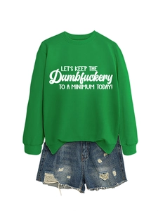 Flat lay of green crewneck sweatshirt with slogan and distressed denim shorts set