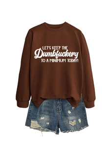 Flat lay of brown long sleeve sweatshirt with white typography and ripped denim shorts