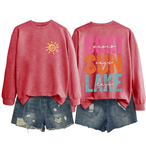 Detail of red Lake Days sweatshirt and distressed denim shorts in flat lay view