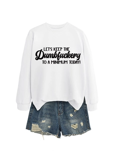Flat lay of a white sweatshirt with slogan paired with distressed denim shorts
